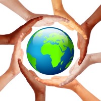 Hands around earth, international friendship concept