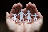 Paper chain family protected in cupped hands Paper chain family protected in cupped hands